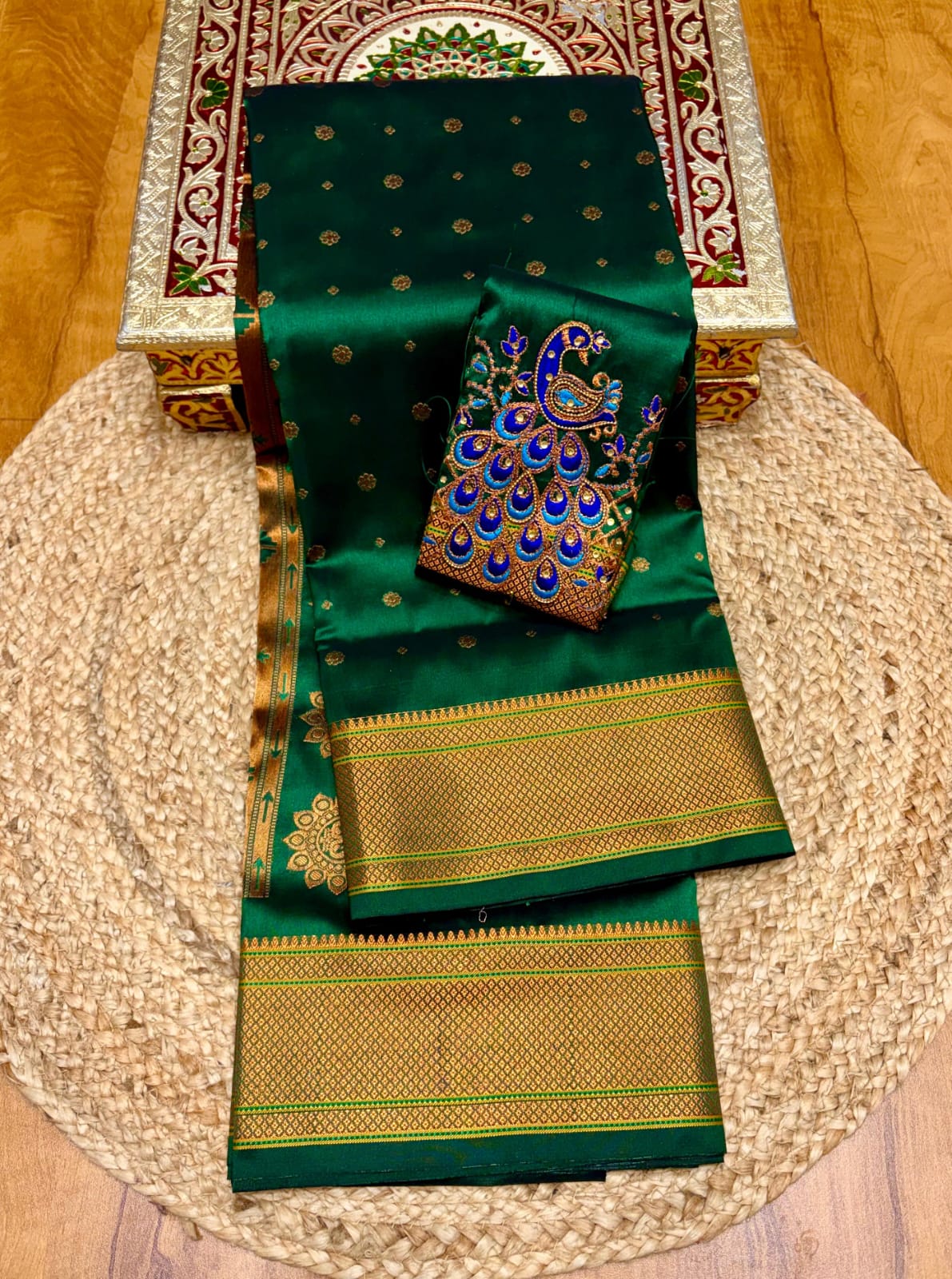 Elevate your festive and wedding wardrobe with the Trisha Kalanjali Paithani Saree, featuring elegant all-over butti weaving, a rich traditional pallu, and a beautifully detailed blouse with Aari work and Diamond Swarovski-style embellishments. Crafted from premium Tana soft silk for a graceful and comfortable drape