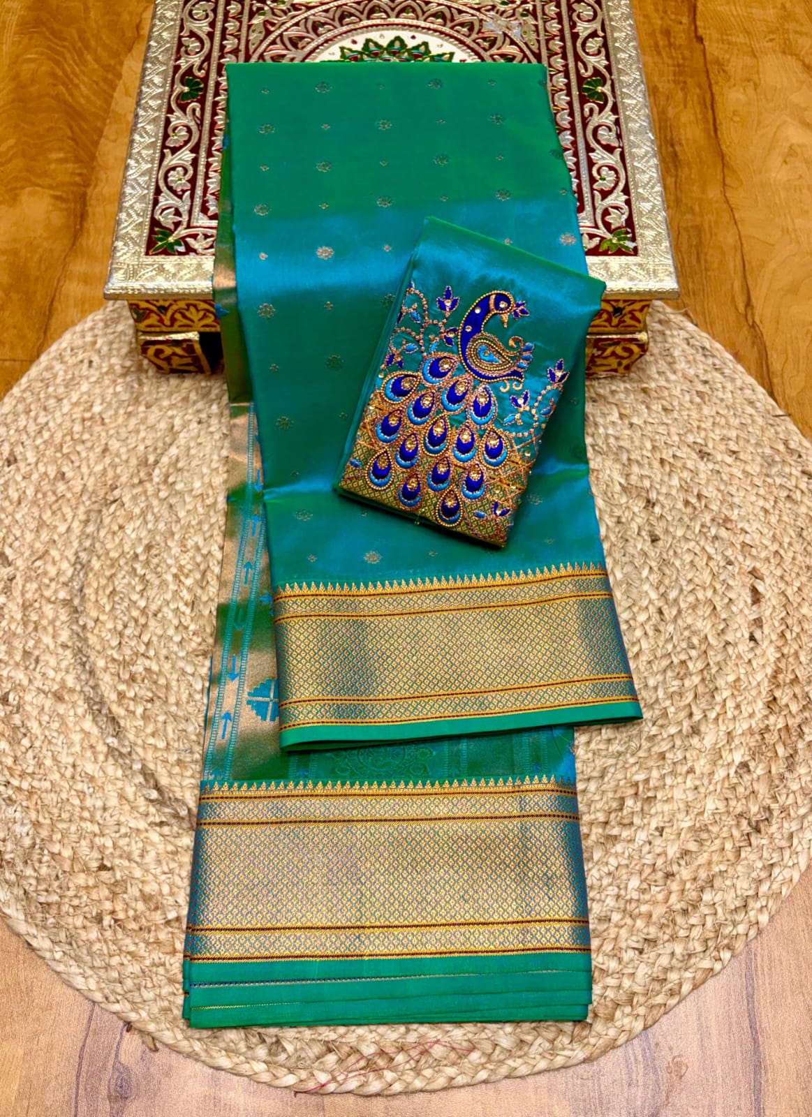 Elevate your festive and wedding wardrobe with the Trisha Kalanjali Paithani Saree, featuring elegant all-over butti weaving, a rich traditional pallu, and a beautifully detailed blouse with Aari work and Diamond Swarovski-style embellishments. Crafted from premium Tana soft silk for a graceful and comfortable drape
