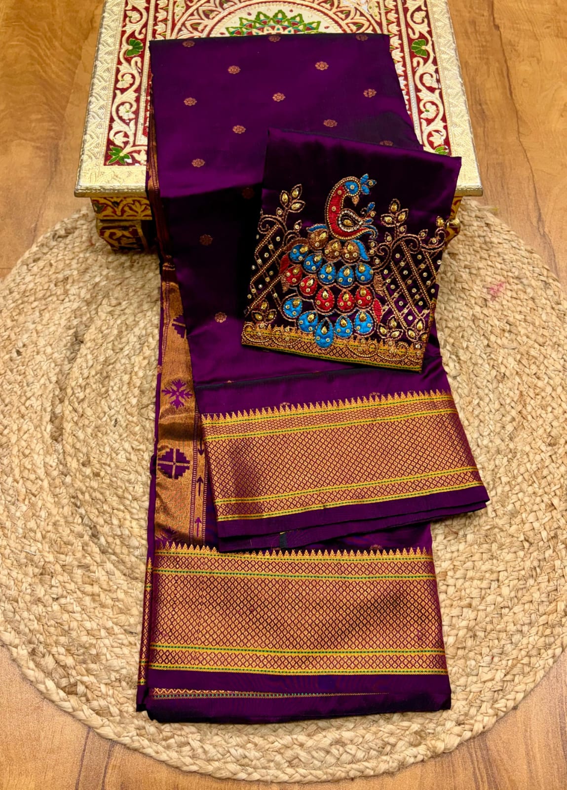 Elevate your festive and wedding wardrobe with the Trisha Kalanjali Paithani Saree, featuring elegant all-over butti weaving, a rich traditional pallu, and a beautifully detailed blouse with Aari work and Diamond Swarovski-style embellishments. Crafted from premium Tana soft silk for a graceful and comfortable drape