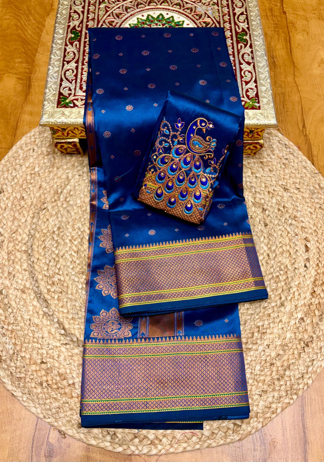 Elevate your festive and wedding wardrobe with the Trisha Kalanjali Paithani Saree, featuring elegant all-over butti weaving, a rich traditional pallu, and a beautifully detailed blouse with Aari work and Diamond Swarovski-style embellishments. Crafted from premium Tana soft silk for a graceful and comfortable drape