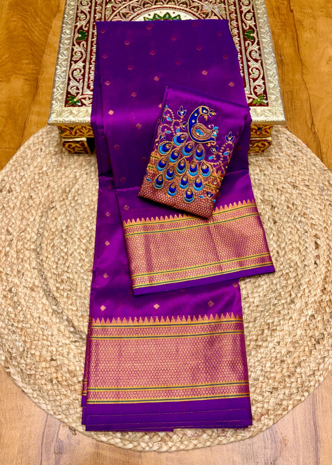 Elevate your festive and wedding wardrobe with the Trisha Kalanjali Paithani Saree, featuring elegant all-over butti weaving, a rich traditional pallu, and a beautifully detailed blouse with Aari work and Diamond Swarovski-style embellishments. Crafted from premium Tana soft silk for a graceful and comfortable drape