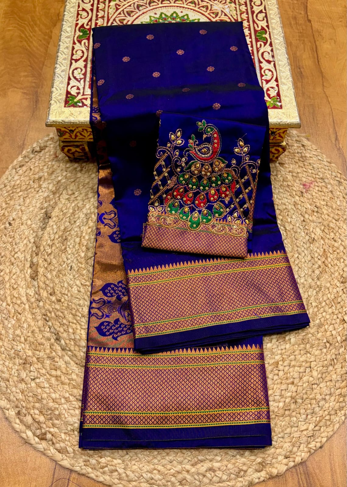 Elevate your festive and wedding wardrobe with the Trisha Kalanjali Paithani Saree, featuring elegant all-over butti weaving, a rich traditional pallu, and a beautifully detailed blouse with Aari work and Diamond Swarovski-style embellishments. Crafted from premium Tana soft silk for a graceful and comfortable drape