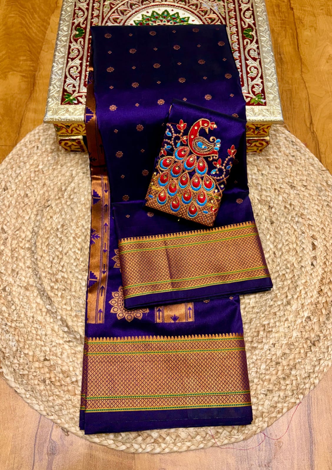 Elevate your festive and wedding wardrobe with the Trisha Kalanjali Paithani Saree, featuring elegant all-over butti weaving, a rich traditional pallu, and a beautifully detailed blouse with Aari work and Diamond Swarovski-style embellishments. Crafted from premium Tana soft silk for a graceful and comfortable drape