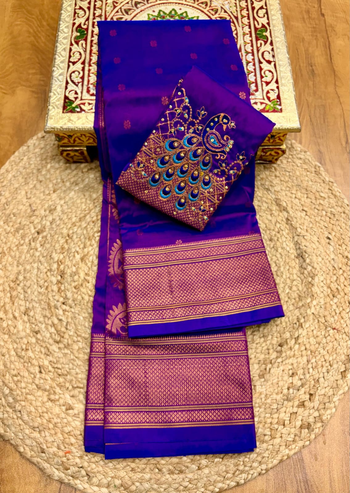 Elevate your festive and wedding wardrobe with the Trisha Kalanjali Paithani Saree, featuring elegant all-over butti weaving, a rich traditional pallu, and a beautifully detailed blouse with Aari work and Diamond Swarovski-style embellishments. Crafted from premium Tana soft silk for a graceful and comfortable drape