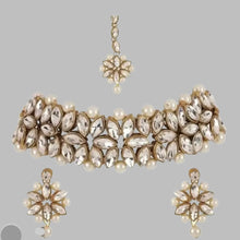 Load image into Gallery viewer, Beautiful Alloy Choker set for women

Color:&nbsp; White and gold
Material: Alloy
Country of Origin: INDIA

Enhance your style with our Beautiful Alloy Choker set for women. Made with high-quality alloy, it is perfect for adding a touch of elegance to any outfit. The sleek design and durability make it a must-have accessory for any fashion-forward woman. Embrace your beauty with this stunning choker set.