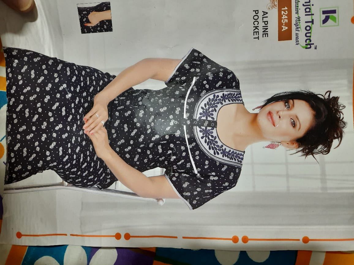 Woman wearing a black and white patterned dress on a magazine page