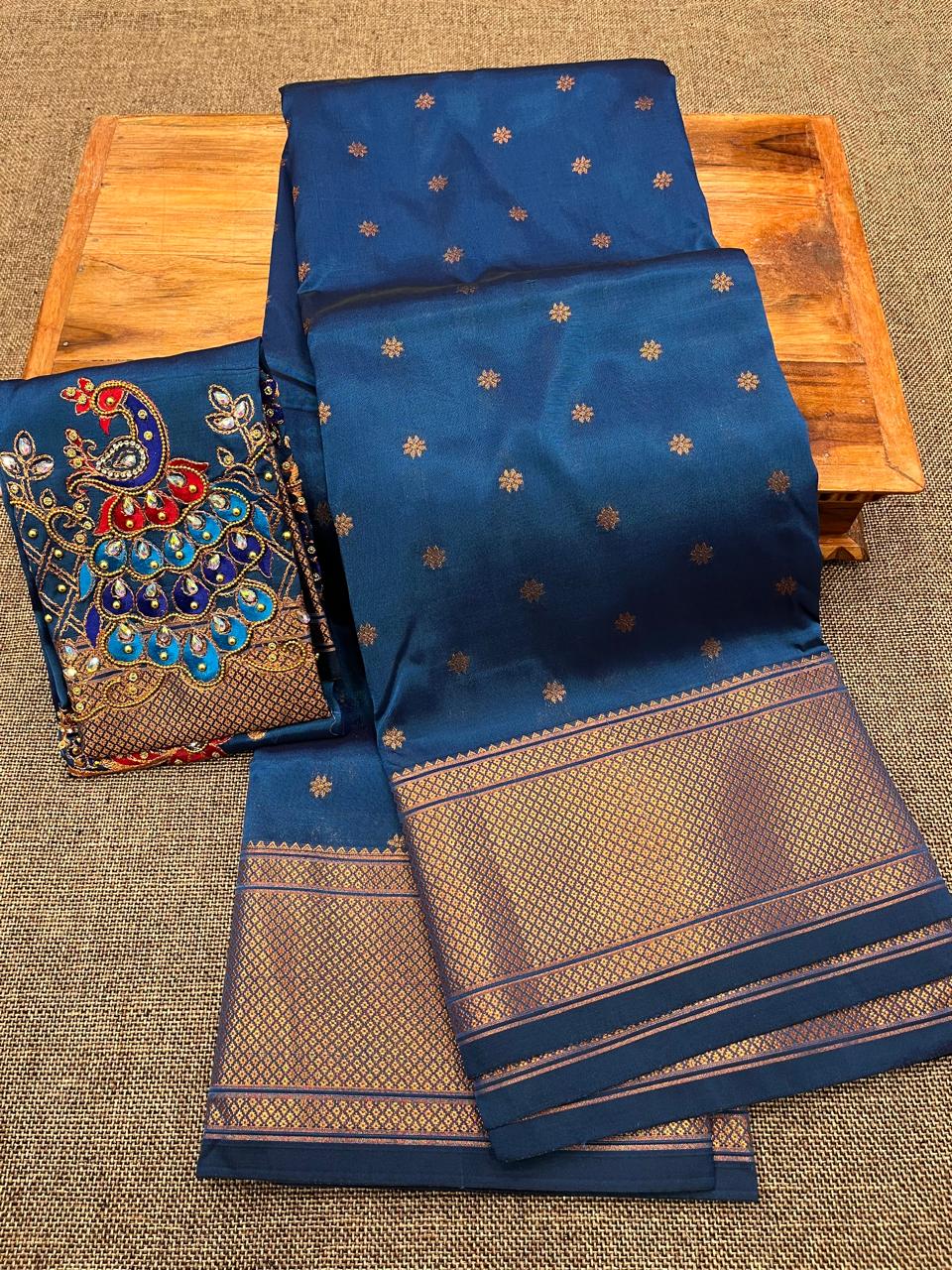 Grace your special occasions with this Traditional Border Kalanjali Paithani Saree, made from soft Tana silk and adorned with all-over buttis, a rich traditional border, and an elegant Aari Work Blouse Piece. Perfect blend of heritage and style for weddings and festive wear.