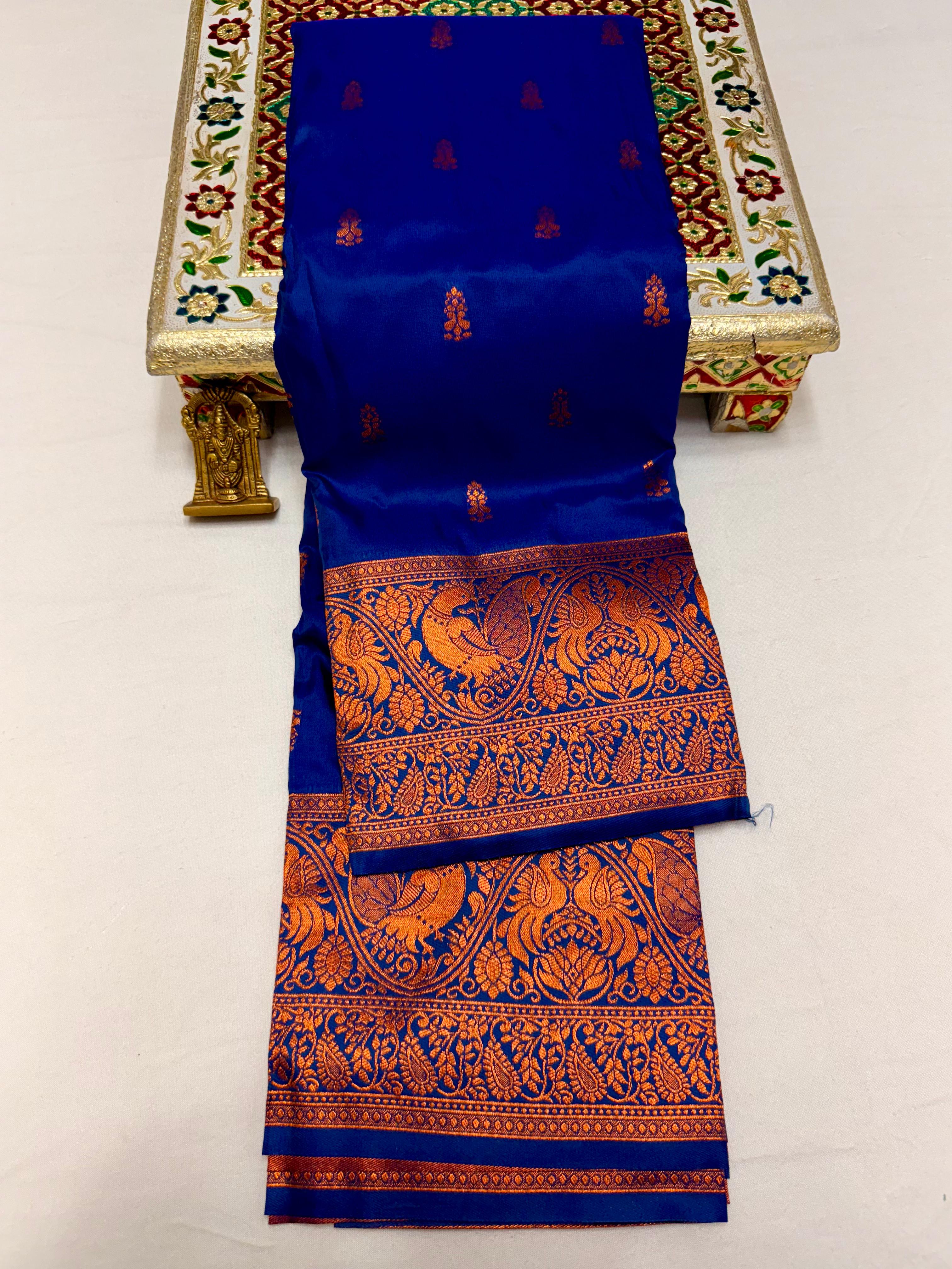 Elevate your ethnic wardrobe with this Mahalaxmi Kanjivaram Paithani Saree, crafted from Pure Soft Silk with rich all-over buttis, a grand pallu, and matching running blouse piece — perfect for festivals and weddings.