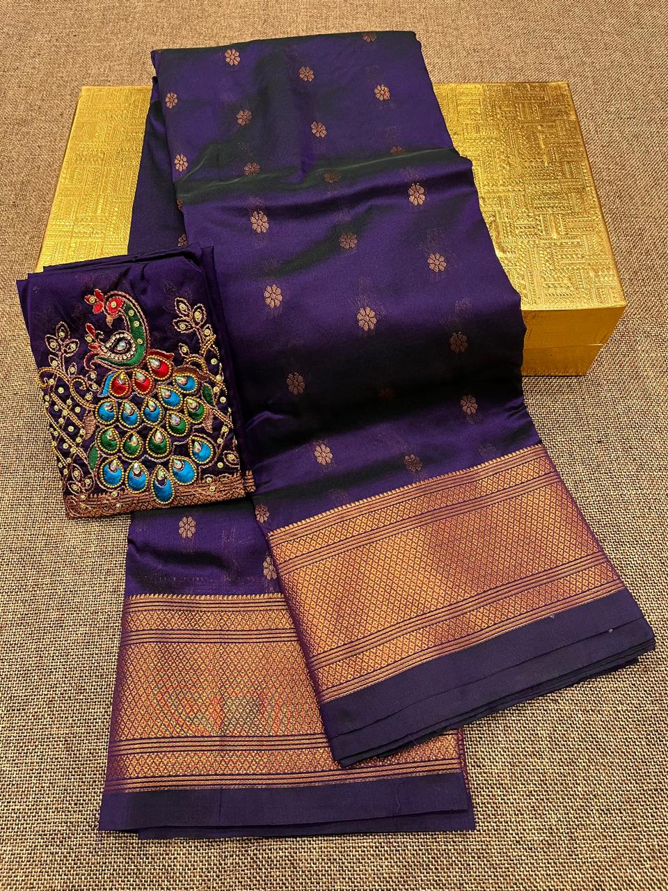 Grace your special occasions with this Traditional Border Kalanjali Paithani Saree, made from soft Tana silk and adorned with all-over buttis, a rich traditional border, and an elegant Aari Work Blouse Piece. Perfect blend of heritage and style for weddings and festive wear.