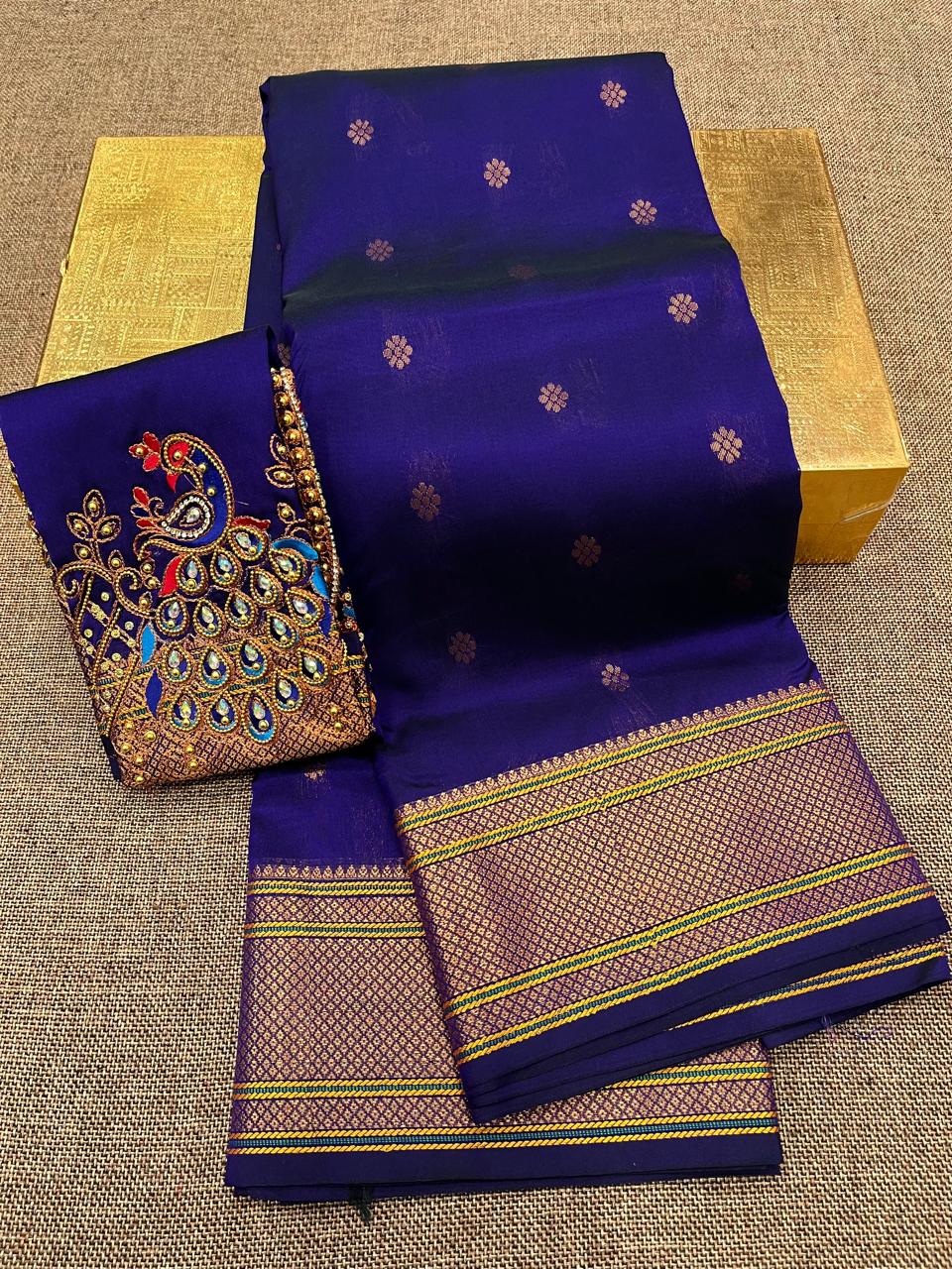 Grace your special occasions with this Traditional Border Kalanjali Paithani Saree, made from soft Tana silk and adorned with all-over buttis, a rich traditional border, and an elegant Aari Work Blouse Piece. Perfect blend of heritage and style for weddings and festive wear.