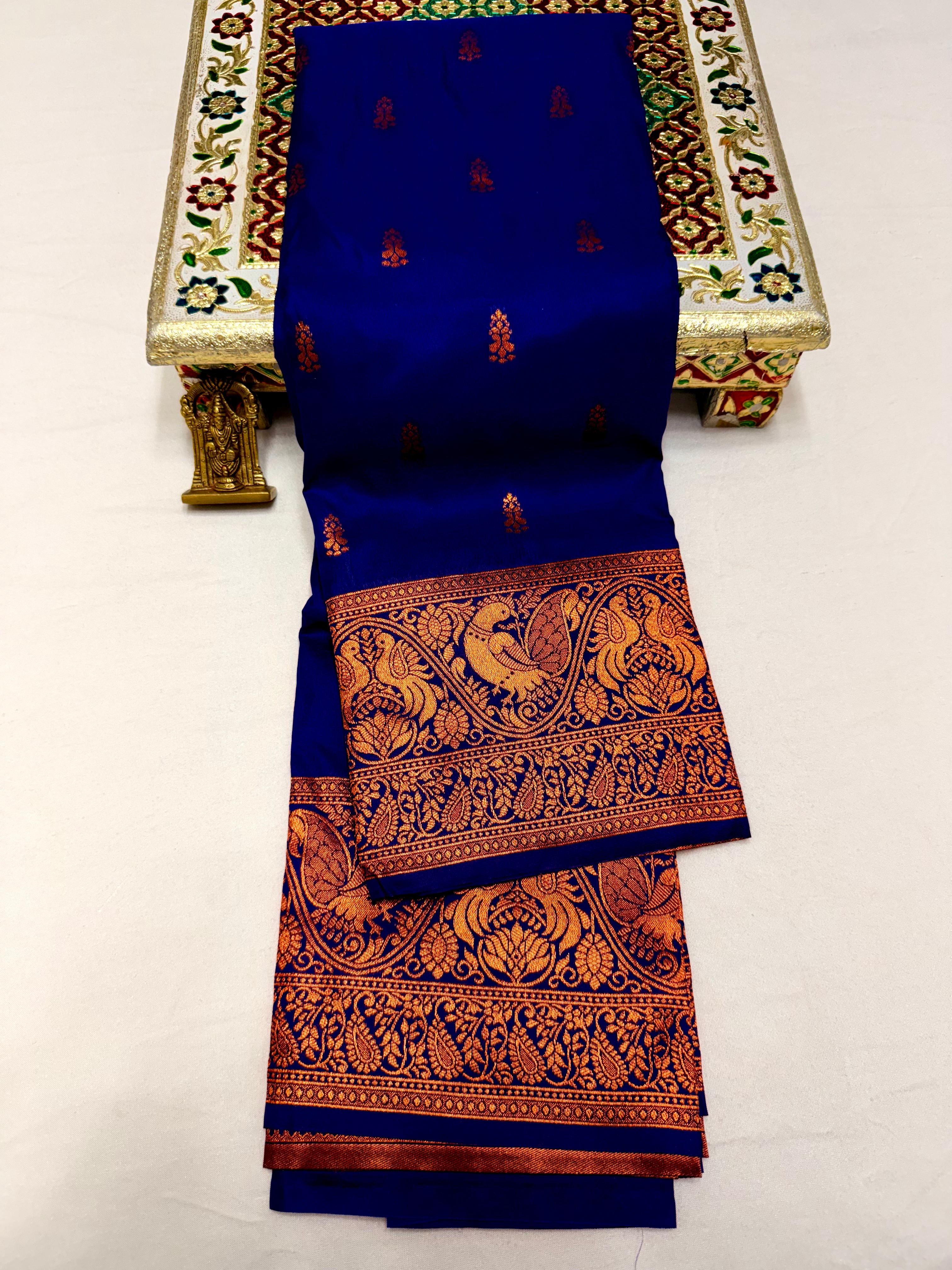 Elevate your ethnic wardrobe with this Mahalaxmi Kanjivaram Paithani Saree, crafted from Pure Soft Silk with rich all-over buttis, a grand pallu, and matching running blouse piece — perfect for festivals and weddings.