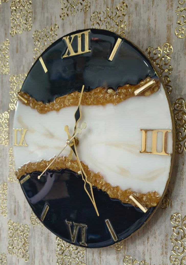 Add a touch of luxury and artistic elegance to your space with the NAVYA Handmade Resin Wall Clock. Expertly crafted using premium-quality resin, this designer clock showcases a mesmerizing marble and agate-inspired pattern with flowing teal, white, and subtle gold accents—making every piece truly one of a kind.