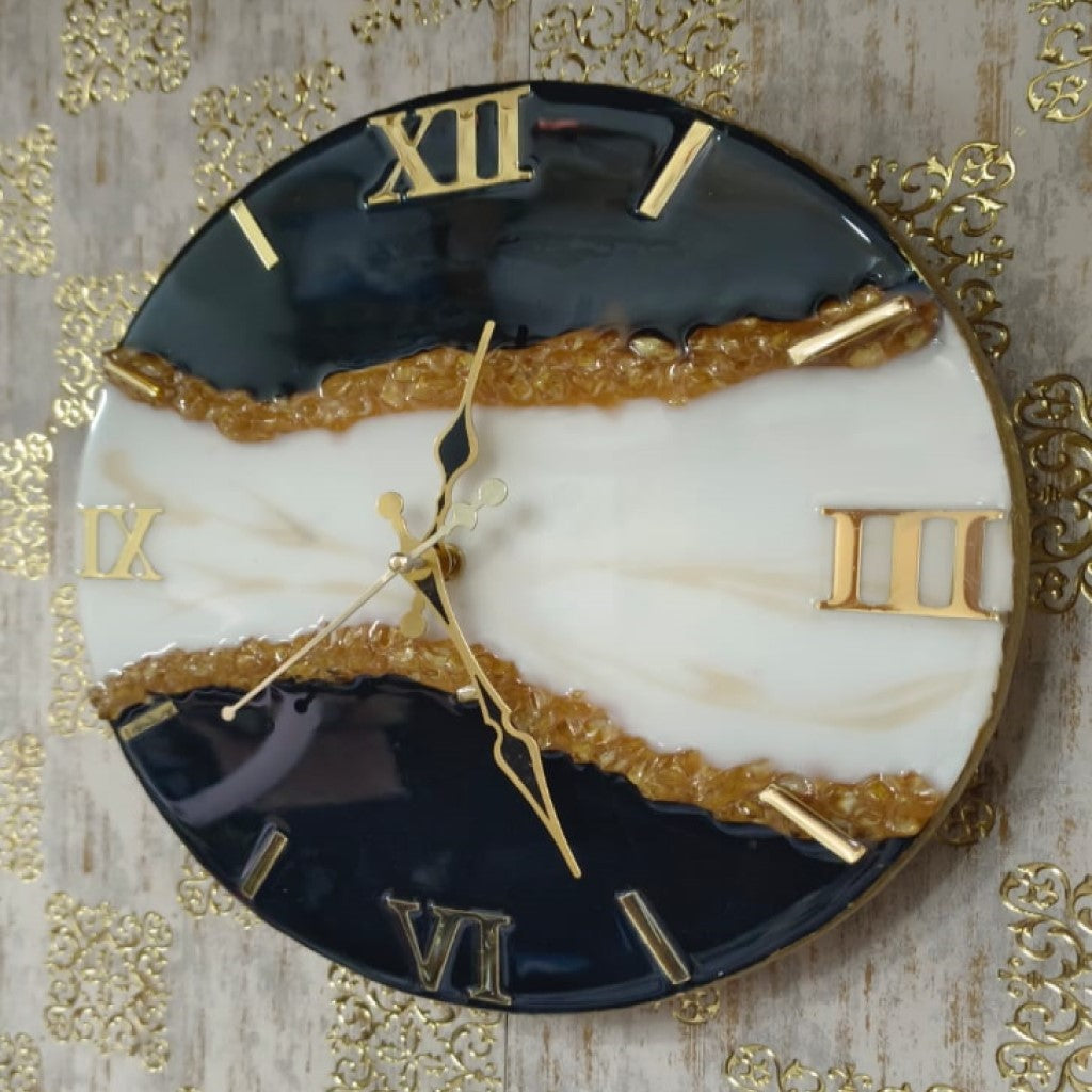Add a touch of luxury and artistic elegance to your space with the NAVYA Handmade Resin Wall Clock. Expertly crafted using premium-quality resin, this designer clock showcases a mesmerizing marble and agate-inspired pattern with flowing teal, white, and subtle gold accents—making every piece truly one of a kind.