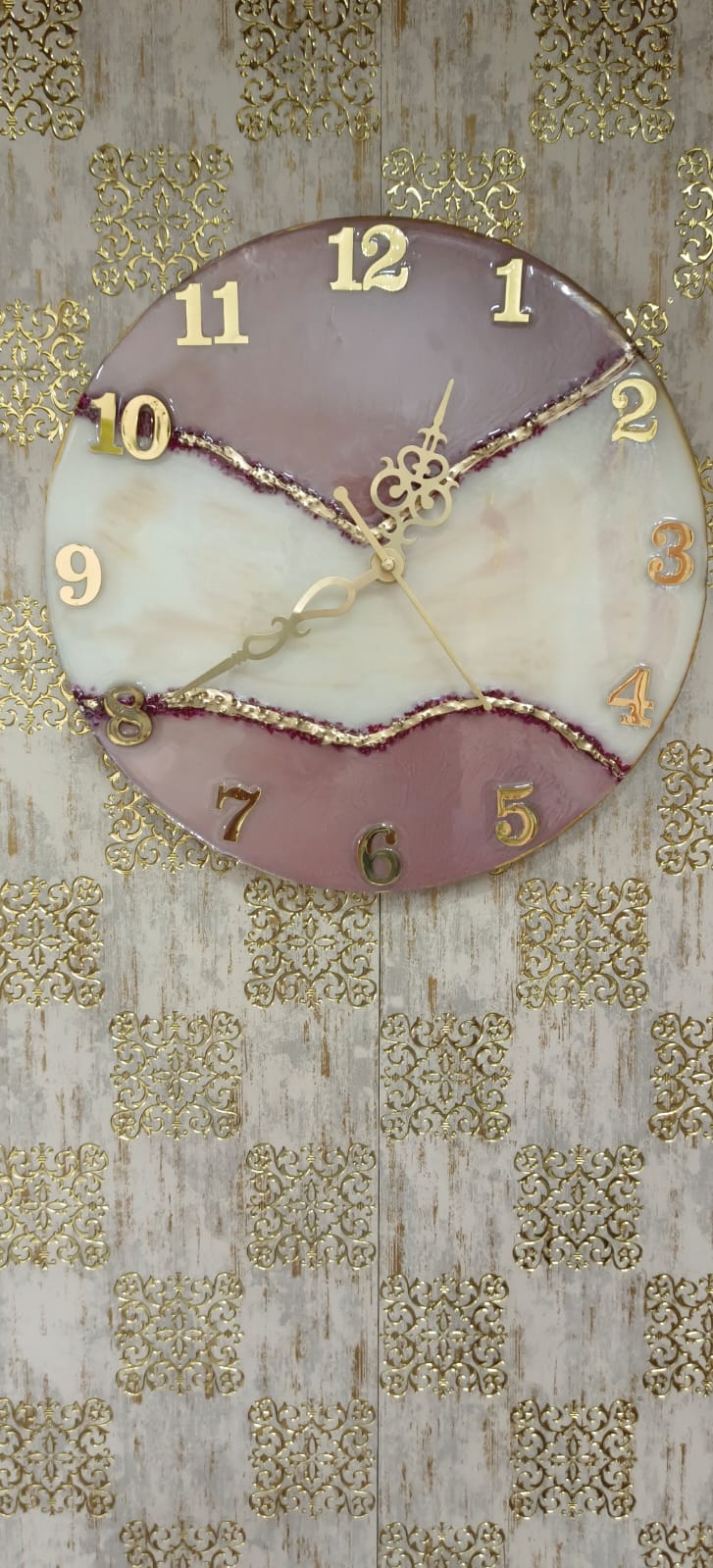 Add a touch of luxury and artistic elegance to your space with the NAVYA Handmade Resin Wall Clock. Expertly crafted using premium-quality resin, this designer clock showcases a mesmerizing marble and agate-inspired pattern with flowing teal, white, and subtle gold accents—making every piece truly one of a kind.