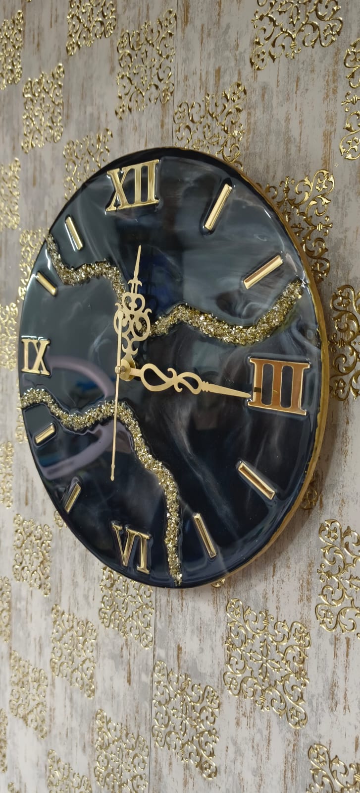 Add a touch of luxury and artistic elegance to your space with the NAVYA Handmade Resin Wall Clock. Expertly crafted using premium-quality resin, this designer clock showcases a mesmerizing marble and agate-inspired pattern with flowing teal, white, and subtle gold accents—making every piece truly one of a kind.
