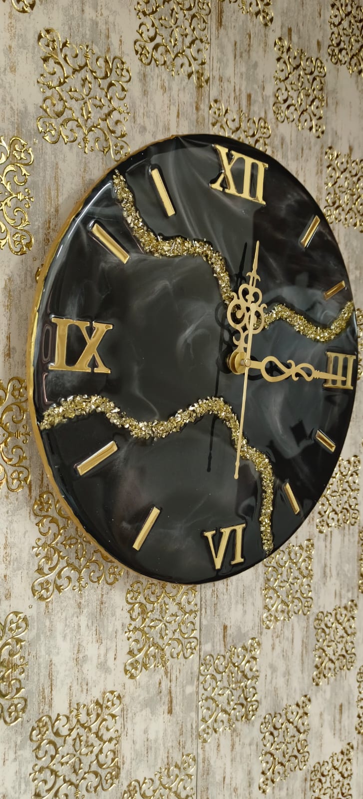 Add a touch of luxury and artistic elegance to your space with the NAVYA Handmade Resin Wall Clock. Expertly crafted using premium-quality resin, this designer clock showcases a mesmerizing marble and agate-inspired pattern with flowing teal, white, and subtle gold accents—making every piece truly one of a kind.