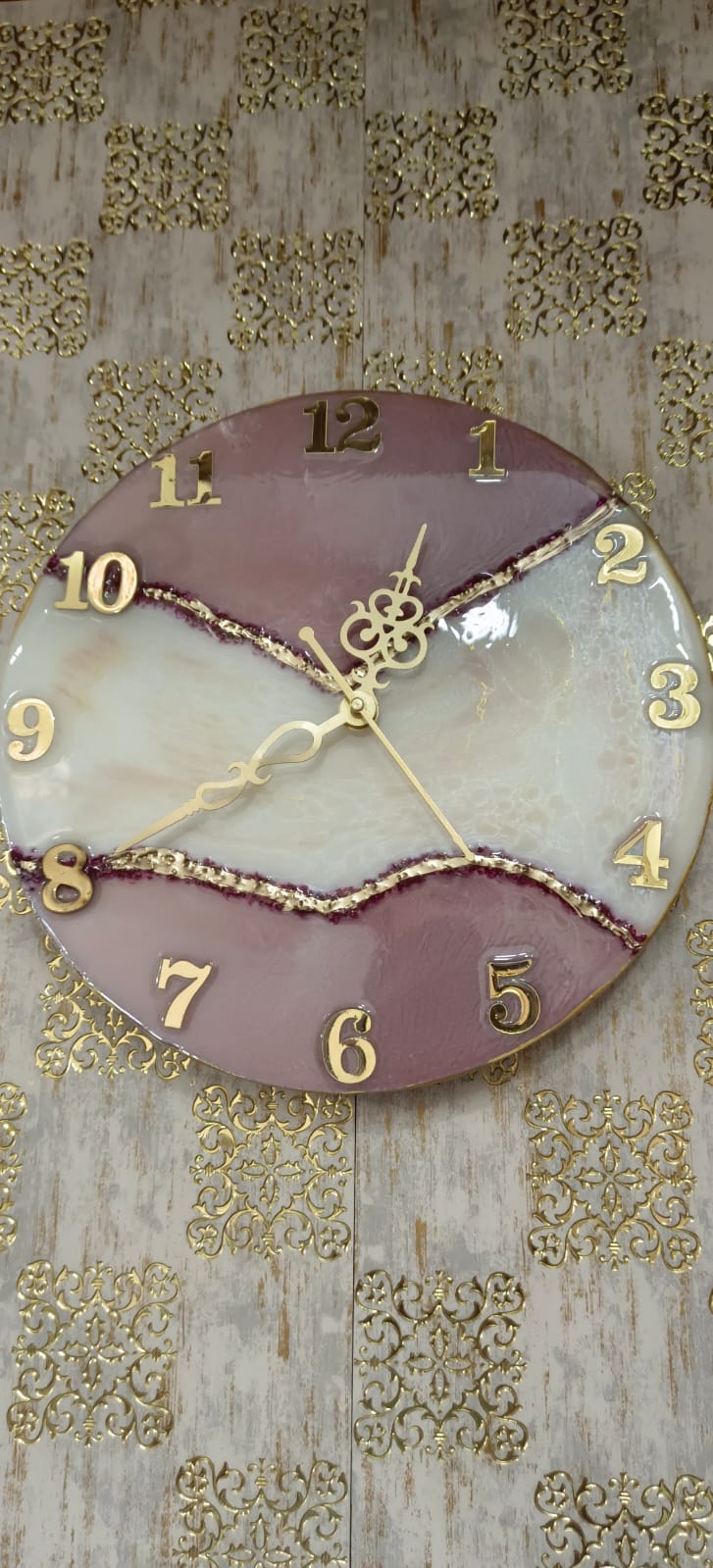 Add a touch of luxury and artistic elegance to your space with the NAVYA Handmade Resin Wall Clock. Expertly crafted using premium-quality resin, this designer clock showcases a mesmerizing marble and agate-inspired pattern with flowing teal, white, and subtle gold accents—making every piece truly one of a kind.