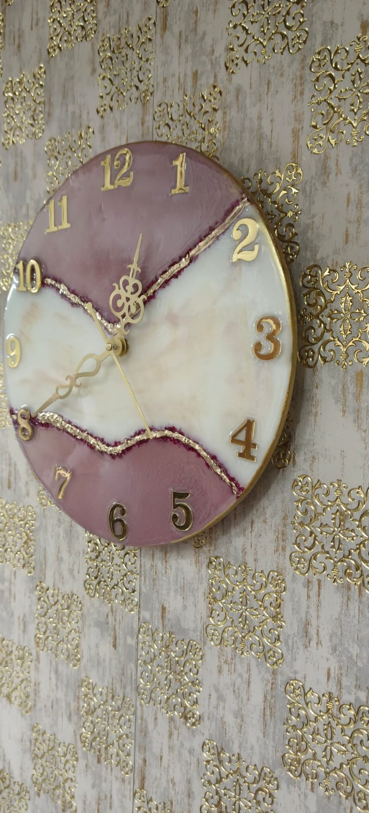 Add a touch of luxury and artistic elegance to your space with the NAVYA Handmade Resin Wall Clock. Expertly crafted using premium-quality resin, this designer clock showcases a mesmerizing marble and agate-inspired pattern with flowing teal, white, and subtle gold accents—making every piece truly one of a kind.