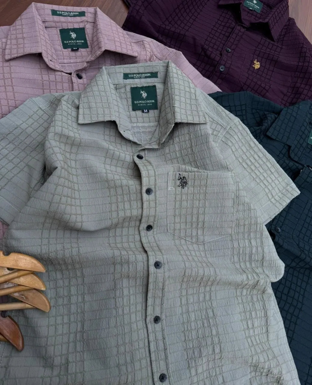 Upgrade your summer wardrobe with the U.S. Polo Premium Popcorn Cotton Self Designer Half Shirt for Men. Crafted from soft breathable fabric with premium embroidery and stylish textured design for a smart casual look.&nbsp;