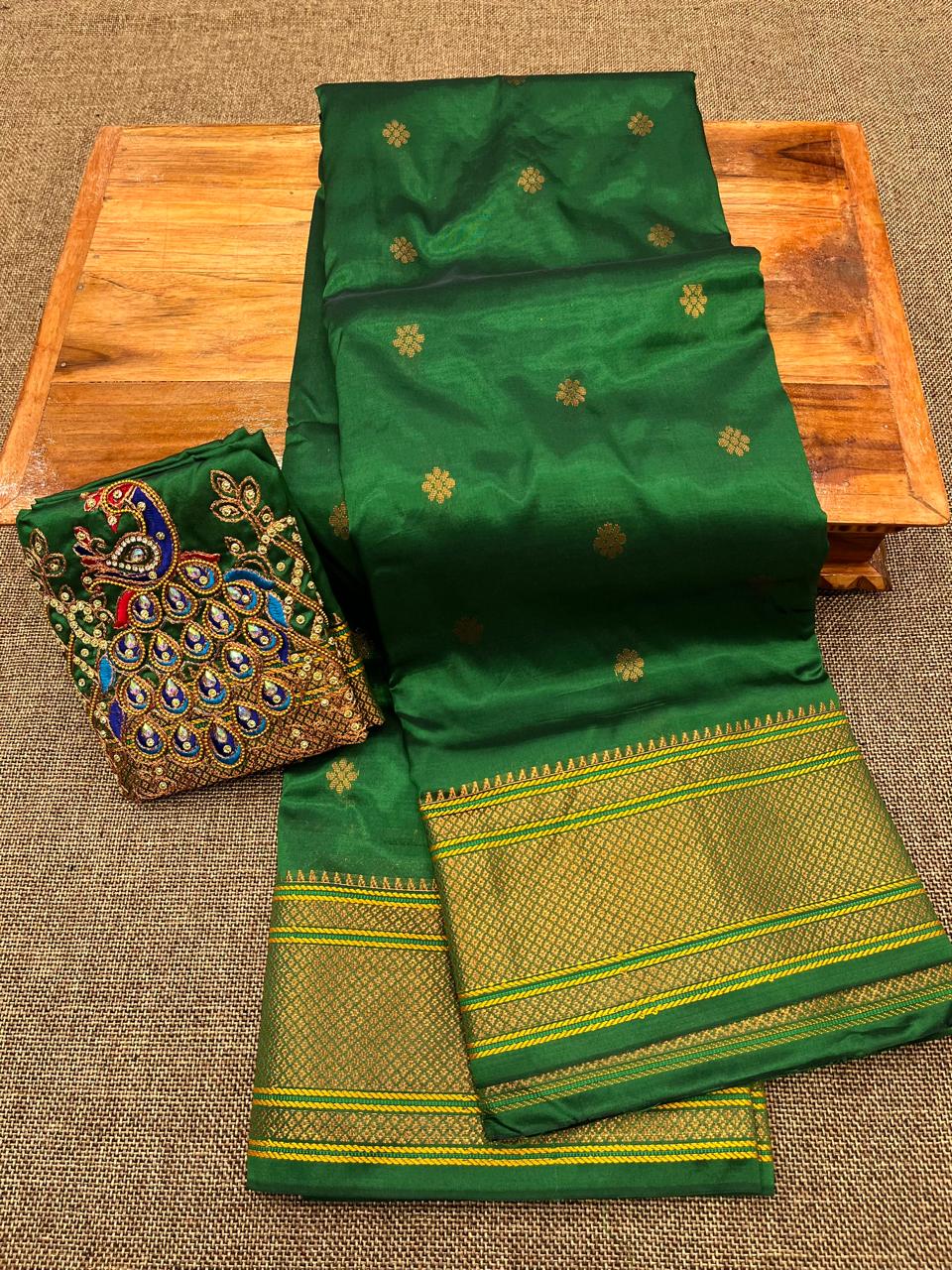 Grace your special occasions with this Traditional Border Kalanjali Paithani Saree, made from soft Tana silk and adorned with all-over buttis, a rich traditional border, and an elegant Aari Work Blouse Piece. Perfect blend of heritage and style for weddings and festive wear.