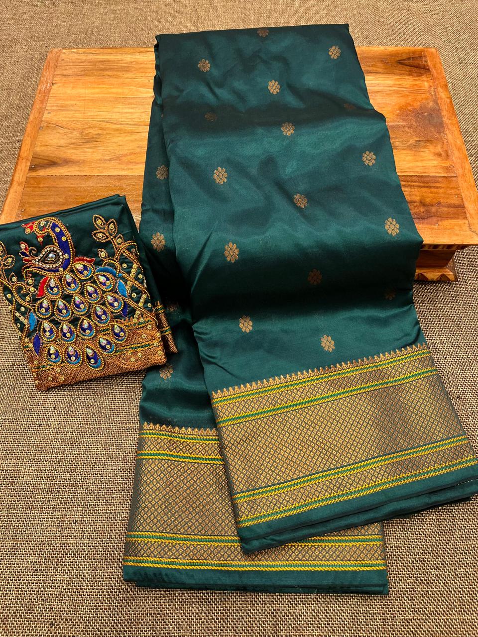 Grace your special occasions with this Traditional Border Kalanjali Paithani Saree, made from soft Tana silk and adorned with all-over buttis, a rich traditional border, and an elegant Aari Work Blouse Piece. Perfect blend of heritage and style for weddings and festive wear.