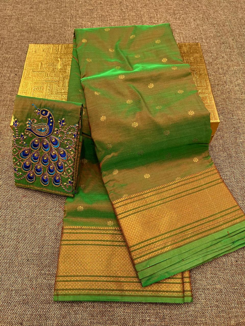 Grace your special occasions with this Traditional Border Kalanjali Paithani Saree, made from soft Tana silk and adorned with all-over buttis, a rich traditional border, and an elegant Aari Work Blouse Piece. Perfect blend of heritage and style for weddings and festive wear.