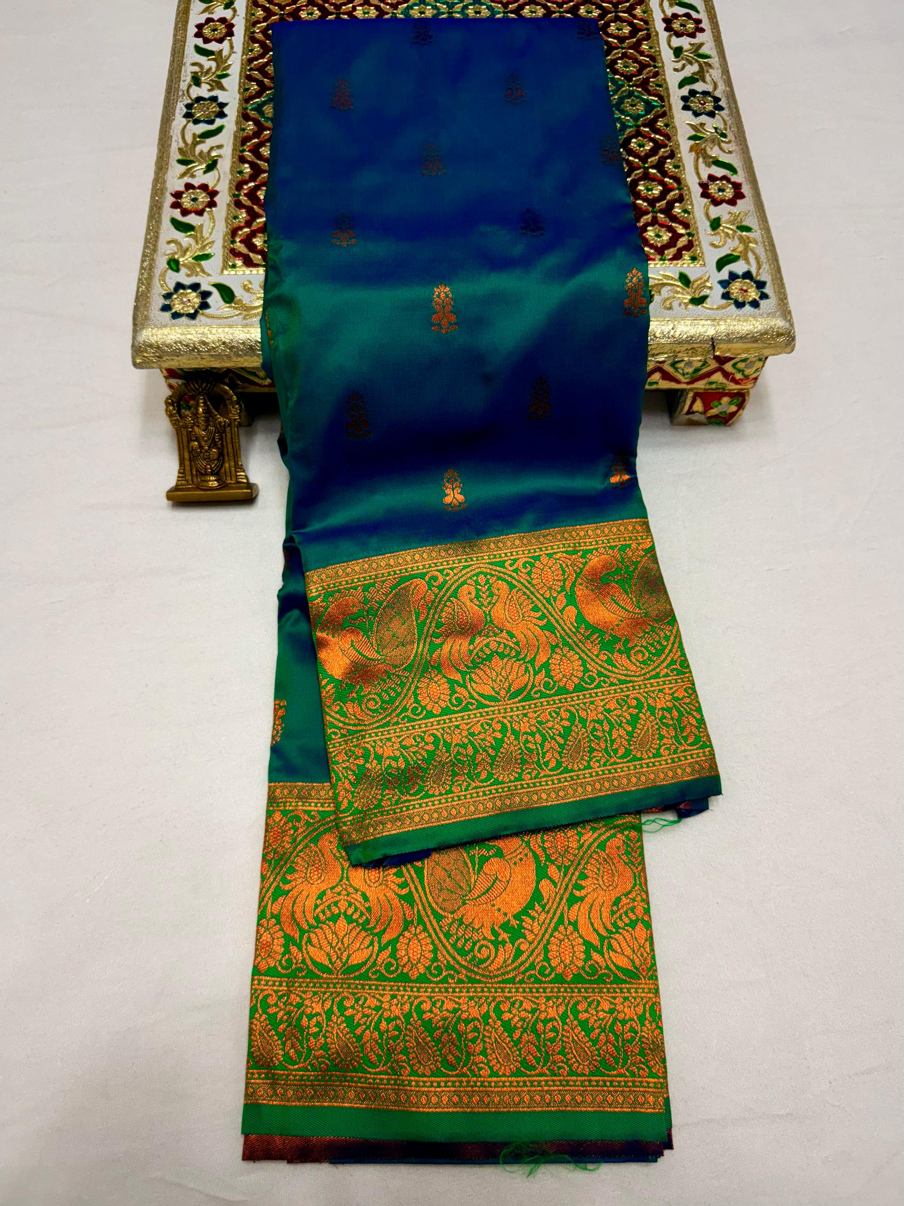 Elevate your ethnic wardrobe with this Mahalaxmi Kanjivaram Paithani Saree, crafted from Pure Soft Silk with rich all-over buttis, a grand pallu, and matching running blouse piece — perfect for festivals and weddings.