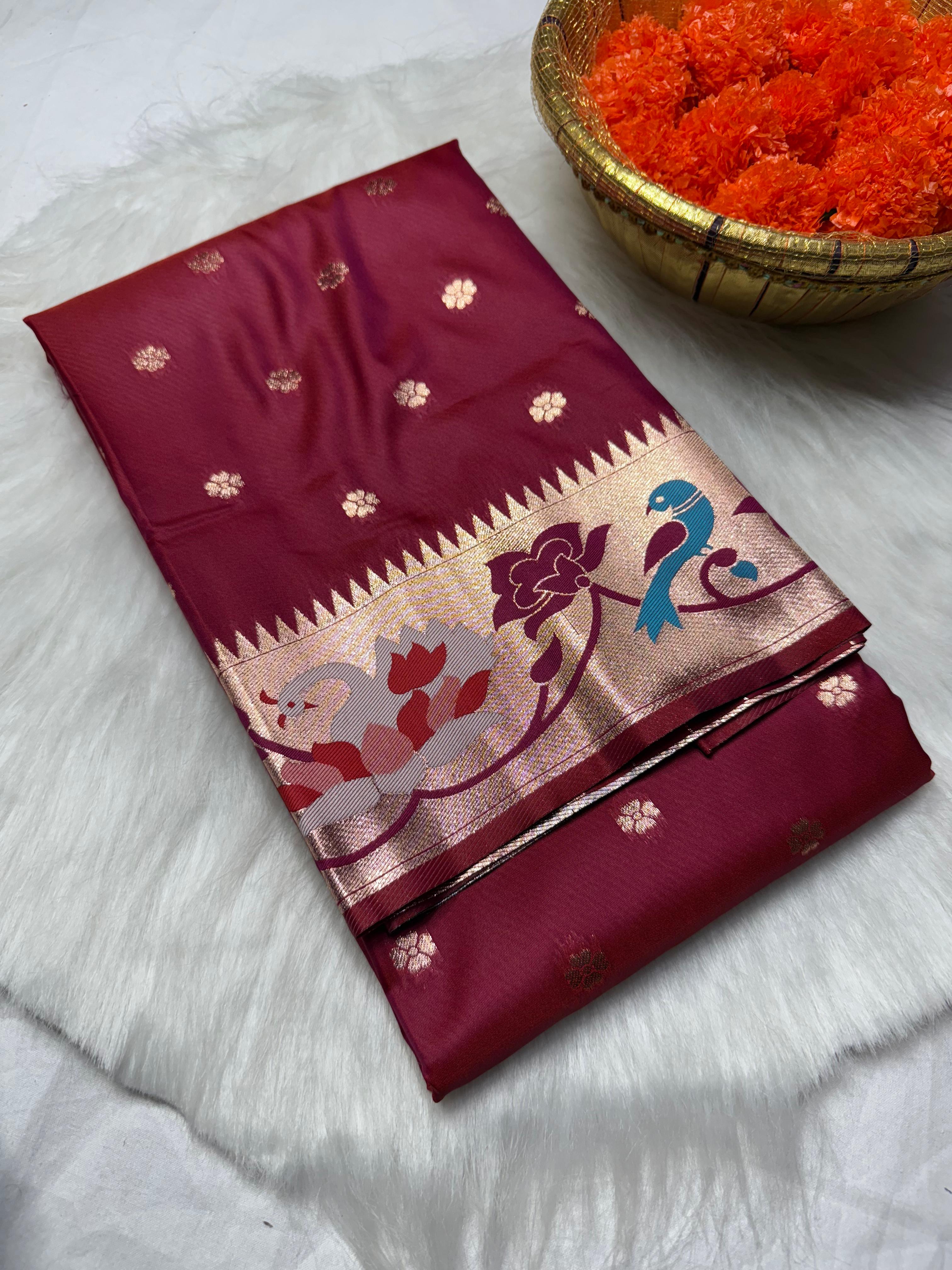 Experience timeless elegance with this Trending Rajhans Brocade Paithani Saree, crafted from premium pure soft silk. Designed with all-over traditional buttis and a luxurious 4/1 rich pallu, this saree reflects royal Maharashtrian craftsmanship. Comes with a matching running blouse piece, making it ideal for weddings, festive occasions, and traditional celebrations.