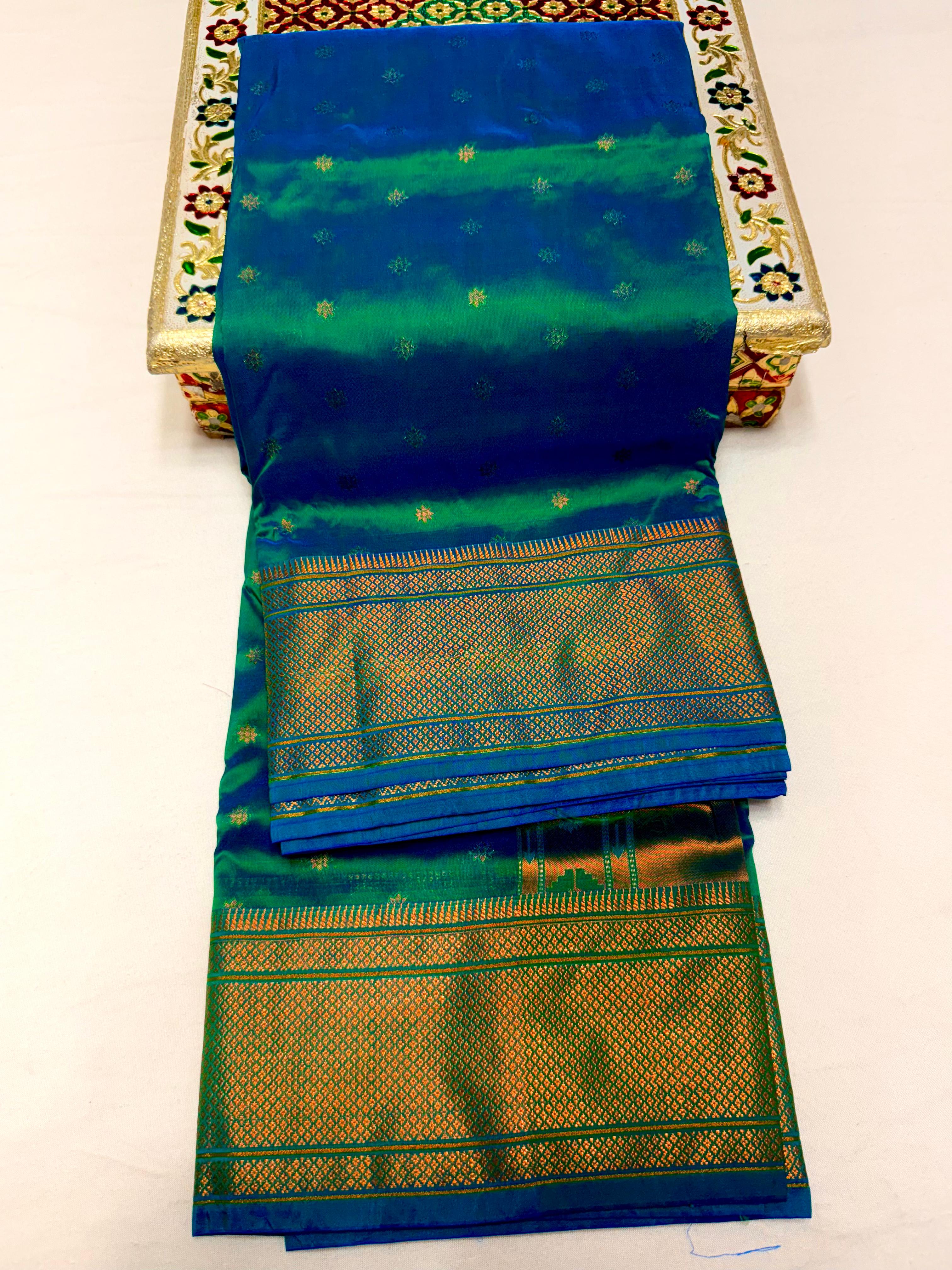 Traditional Tana Silk Kalanjali Paithani with rich Maharani pallu, crafted in premium pure soft silk. Featuring all-over Karnfuli butti, classic traditional border, and running blouse piece. A viral trending Paithani saree perfect for weddings, festivals, and special occasions.