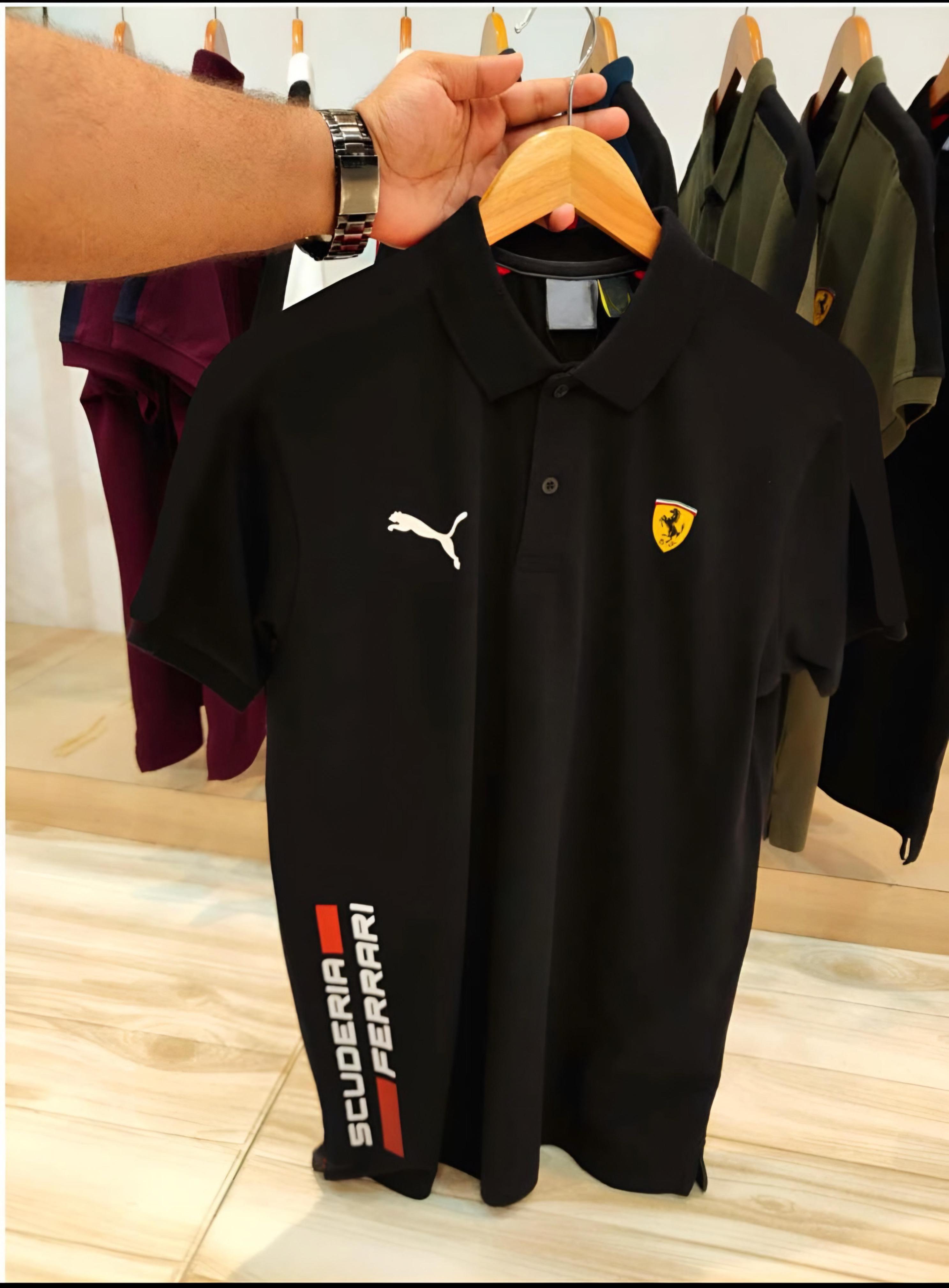Experience sporty elegance with the Puma Ferrari Premium Matty Cotton Collar T-Shirt for Men. Crafted from 100% SAPP Matty Cotton, this tee combines comfort, durability, and iconic style. Featuring a structured collar, sleek finish, and official Puma x Ferrari branding, it’s designed to give you that effortlessly smart look – whether you're heading out or dressing casual. Choose from 4 bold colors and make every outing a style statement.