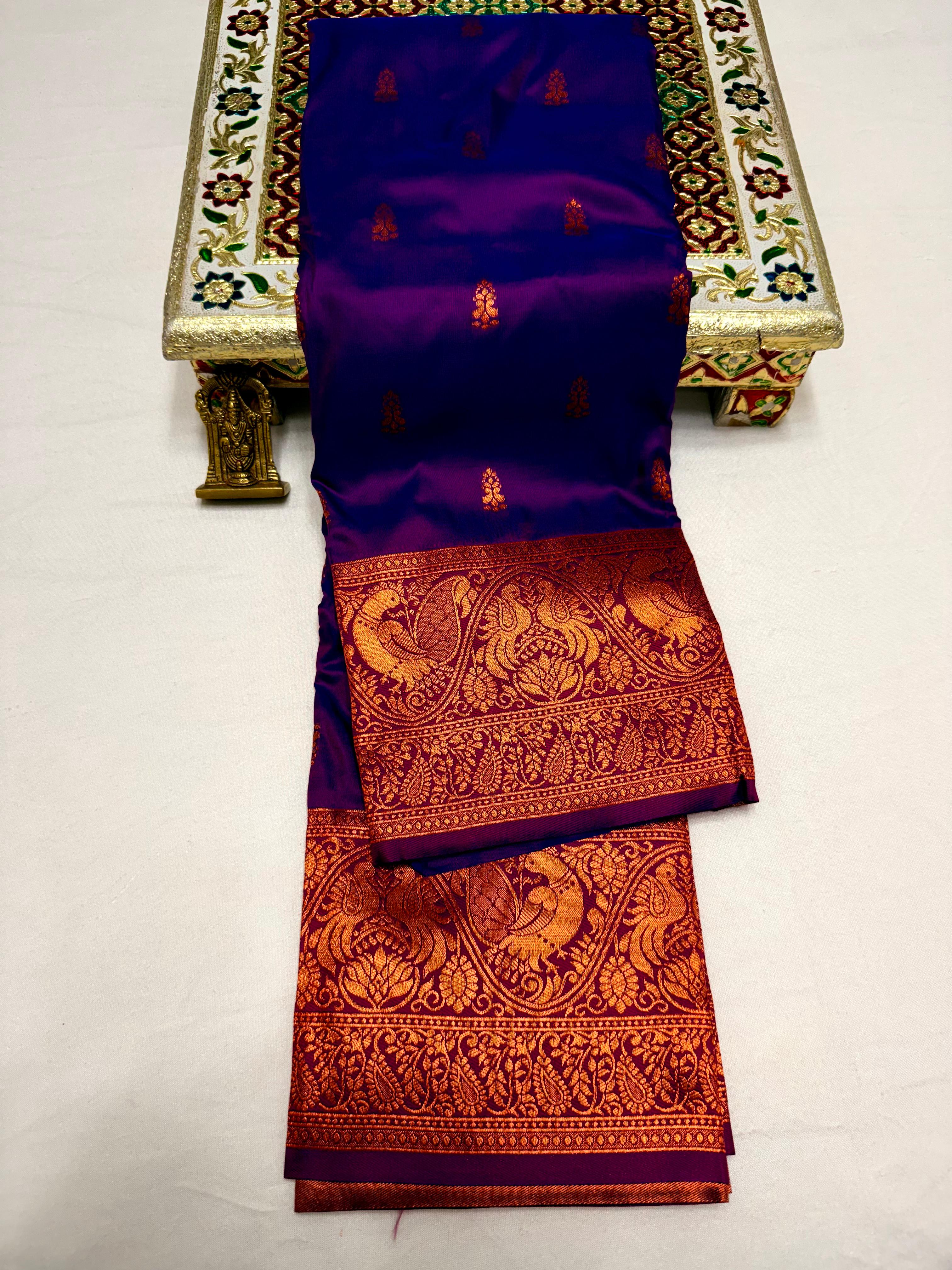 Elevate your ethnic wardrobe with this Mahalaxmi Kanjivaram Paithani Saree, crafted from Pure Soft Silk with rich all-over buttis, a grand pallu, and matching running blouse piece — perfect for festivals and weddings.