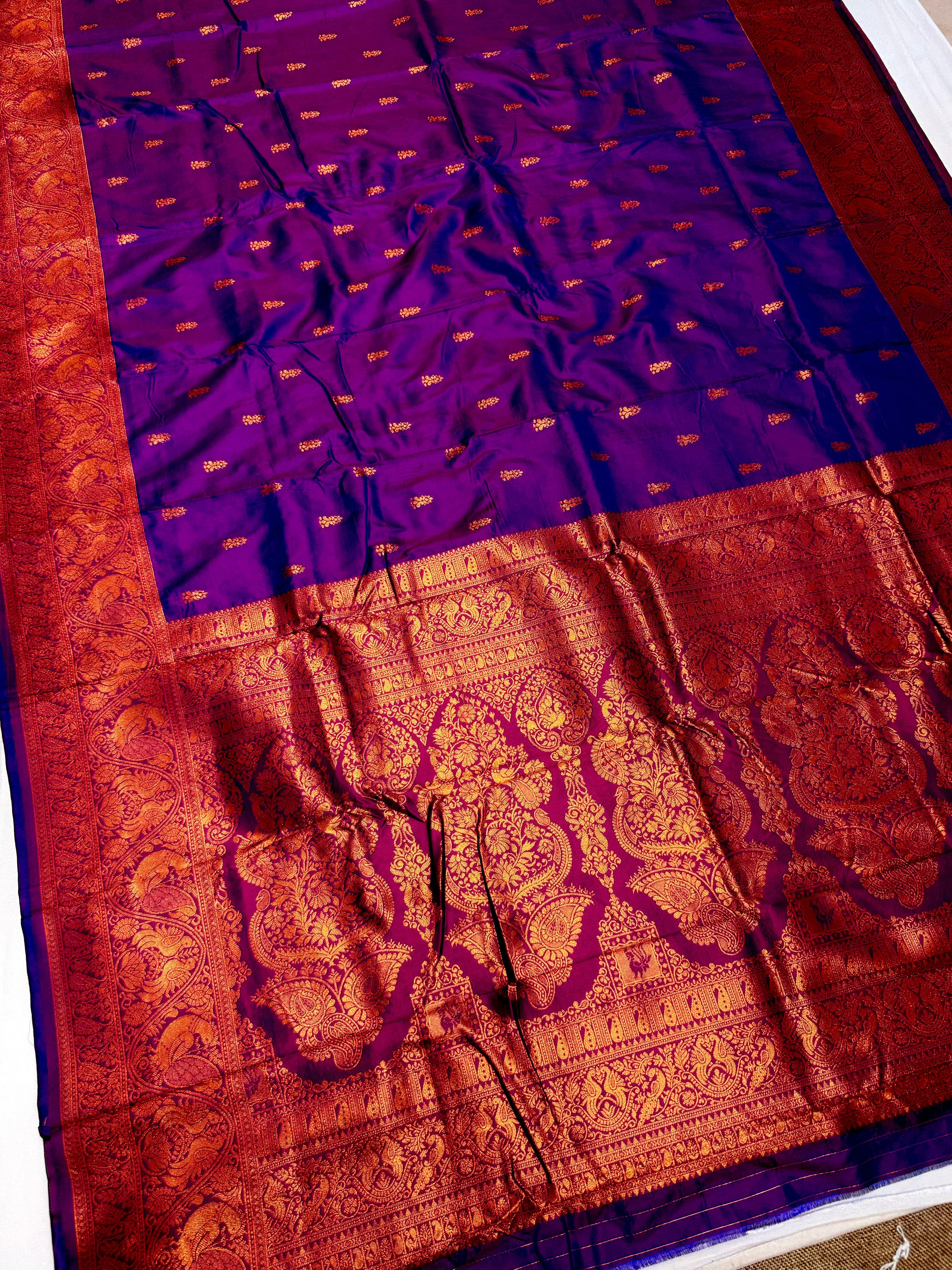Elevate your ethnic wardrobe with this Mahalaxmi Kanjivaram Paithani Saree, crafted from Pure Soft Silk with rich all-over buttis, a grand pallu, and matching running blouse piece — perfect for festivals and weddings.