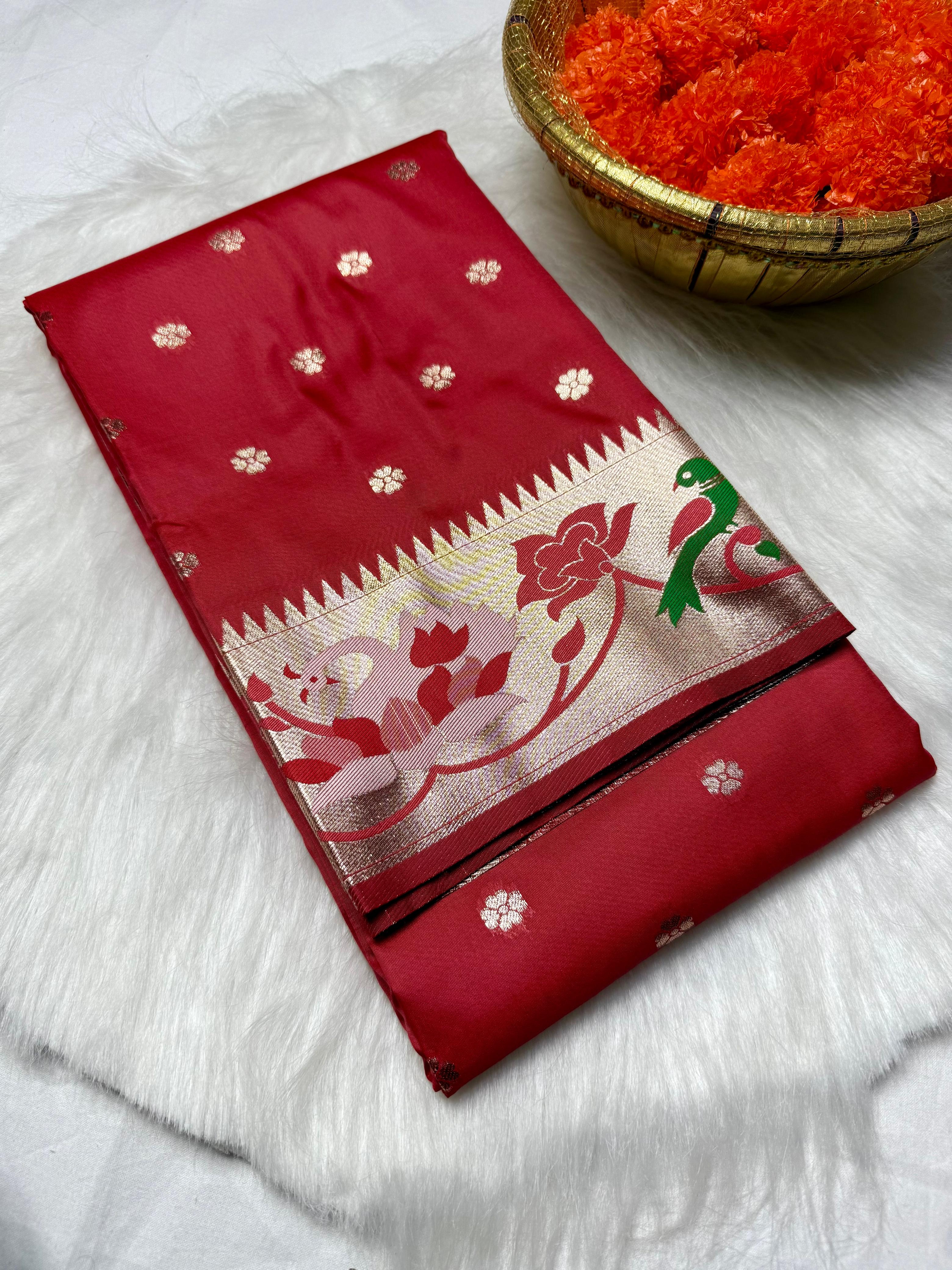 Experience timeless elegance with this Trending Rajhans Brocade Paithani Saree, crafted from premium pure soft silk. Designed with all-over traditional buttis and a luxurious 4/1 rich pallu, this saree reflects royal Maharashtrian craftsmanship. Comes with a matching running blouse piece, making it ideal for weddings, festive occasions, and traditional celebrations.