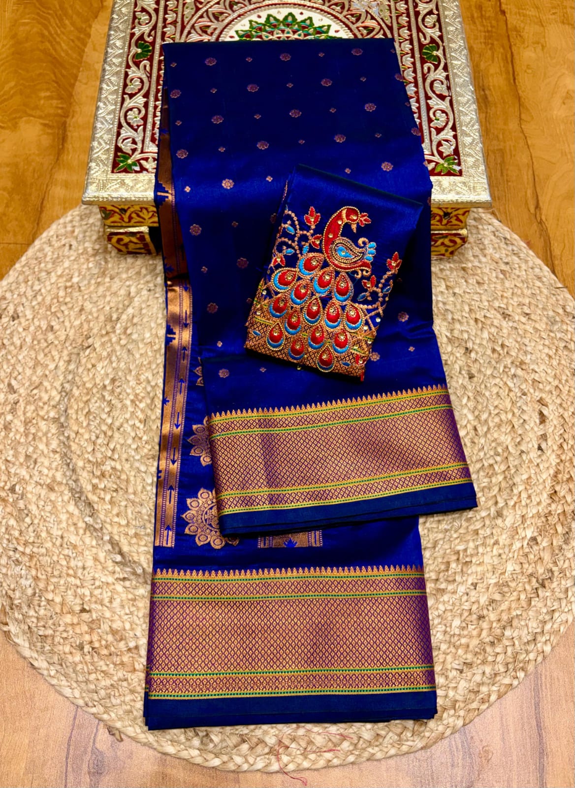 Elevate your festive and wedding wardrobe with the Trisha Kalanjali Paithani Saree, featuring elegant all-over butti weaving, a rich traditional pallu, and a beautifully detailed blouse with Aari work and Diamond Swarovski-style embellishments. Crafted from premium Tana soft silk for a graceful and comfortable drape.