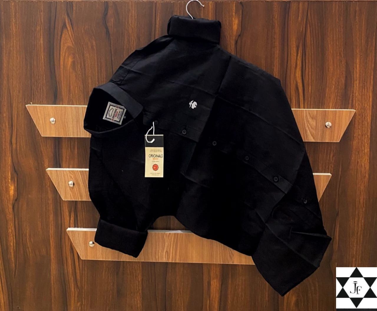 Black shirt on a hanger with a wooden background