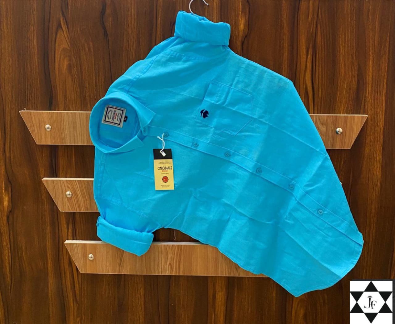 Blue shirt on a hanger against a wooden background