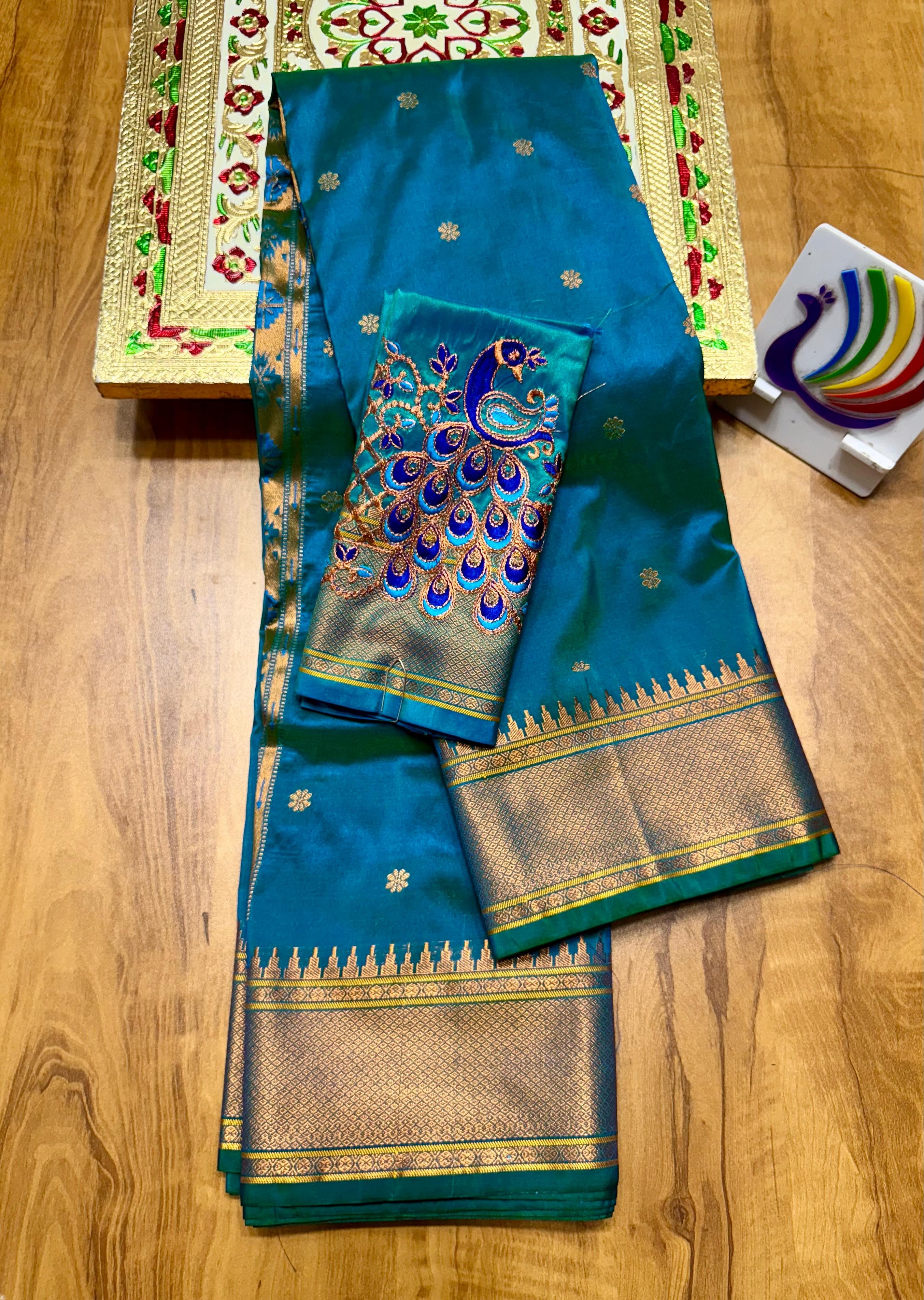 Discover the richness of tradition with our New Launching Kalanjali Bindiya Paithani Saree, a timeless creation woven in premium soft; shiny Tana silk. Designed with all-over buttis, a rich intricately styled pallu, and a copper zari border small temple, this saree reflects true craftsmanship and cultural heritage.