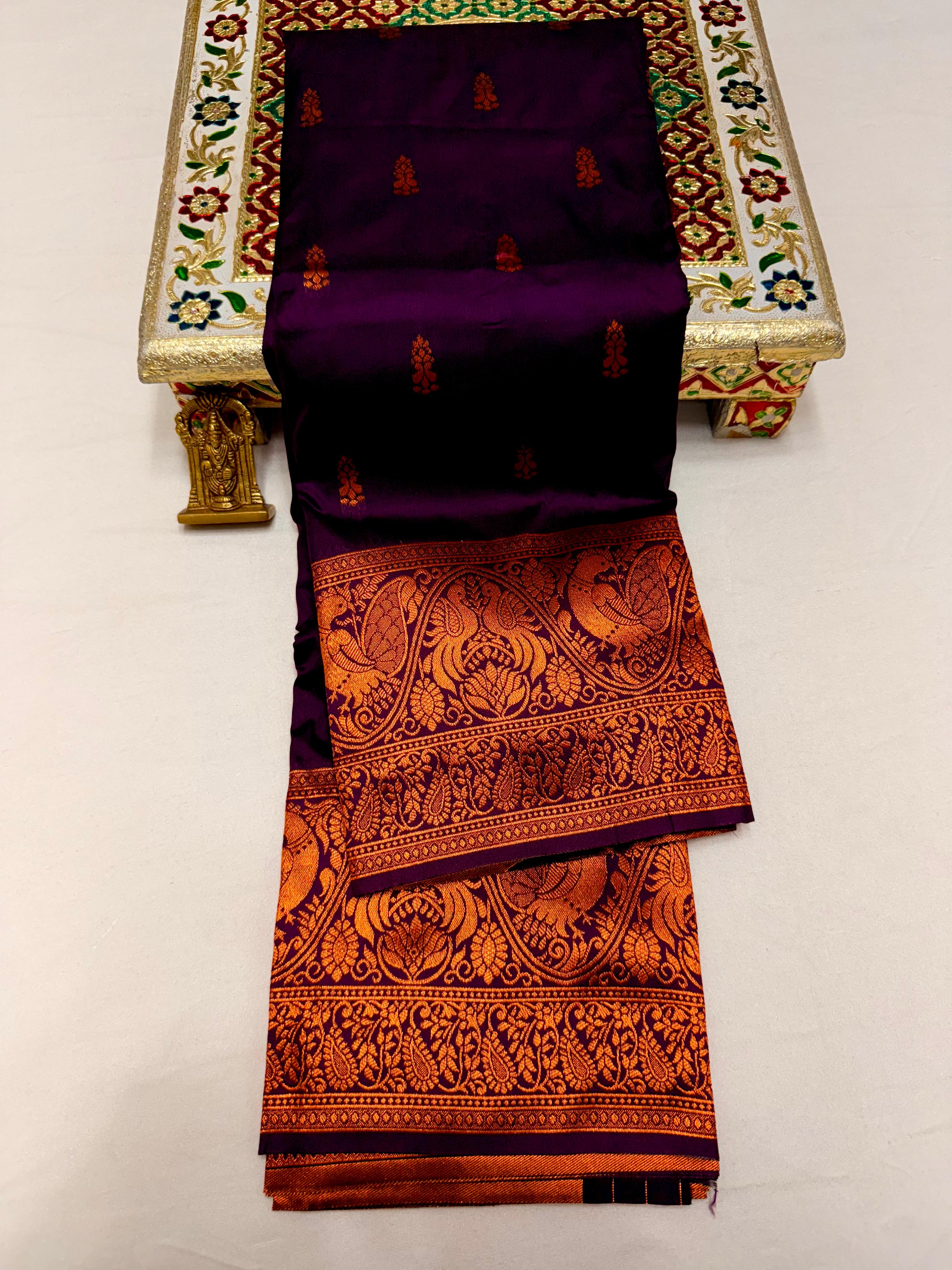 Elevate your ethnic wardrobe with this Mahalaxmi Kanjivaram Paithani Saree, crafted from Pure Soft Silk with rich all-over buttis, a grand pallu, and matching running blouse piece — perfect for festivals and weddings.