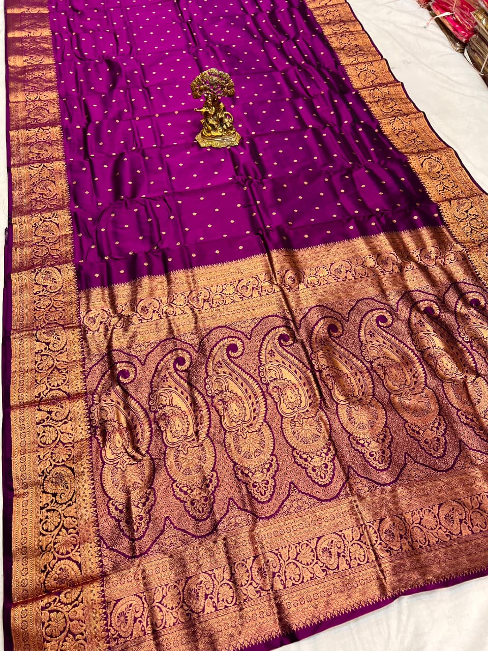 Purple and brown saree with intricate patterns on a white background