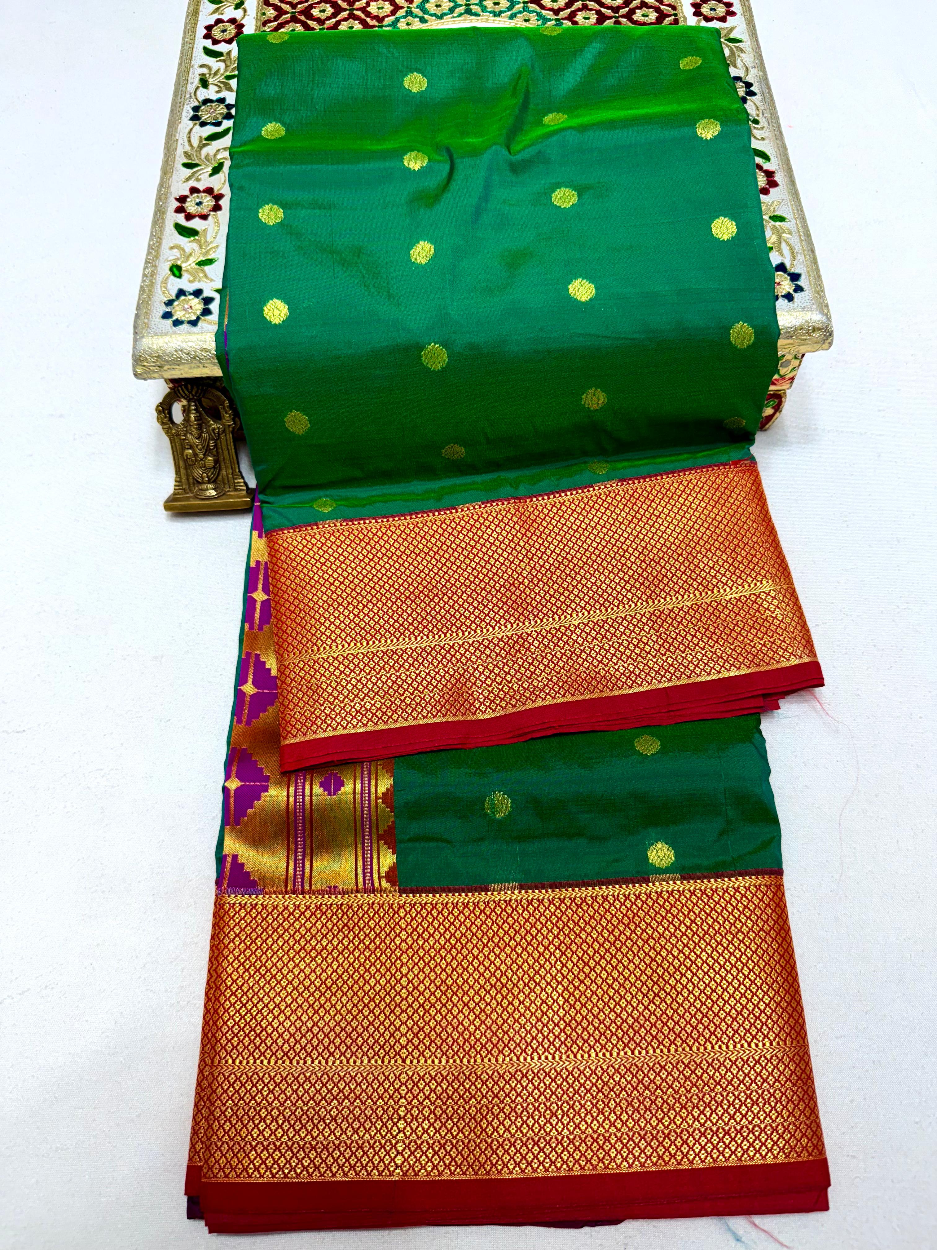 Traditional saree with green and orange patterns on a white background