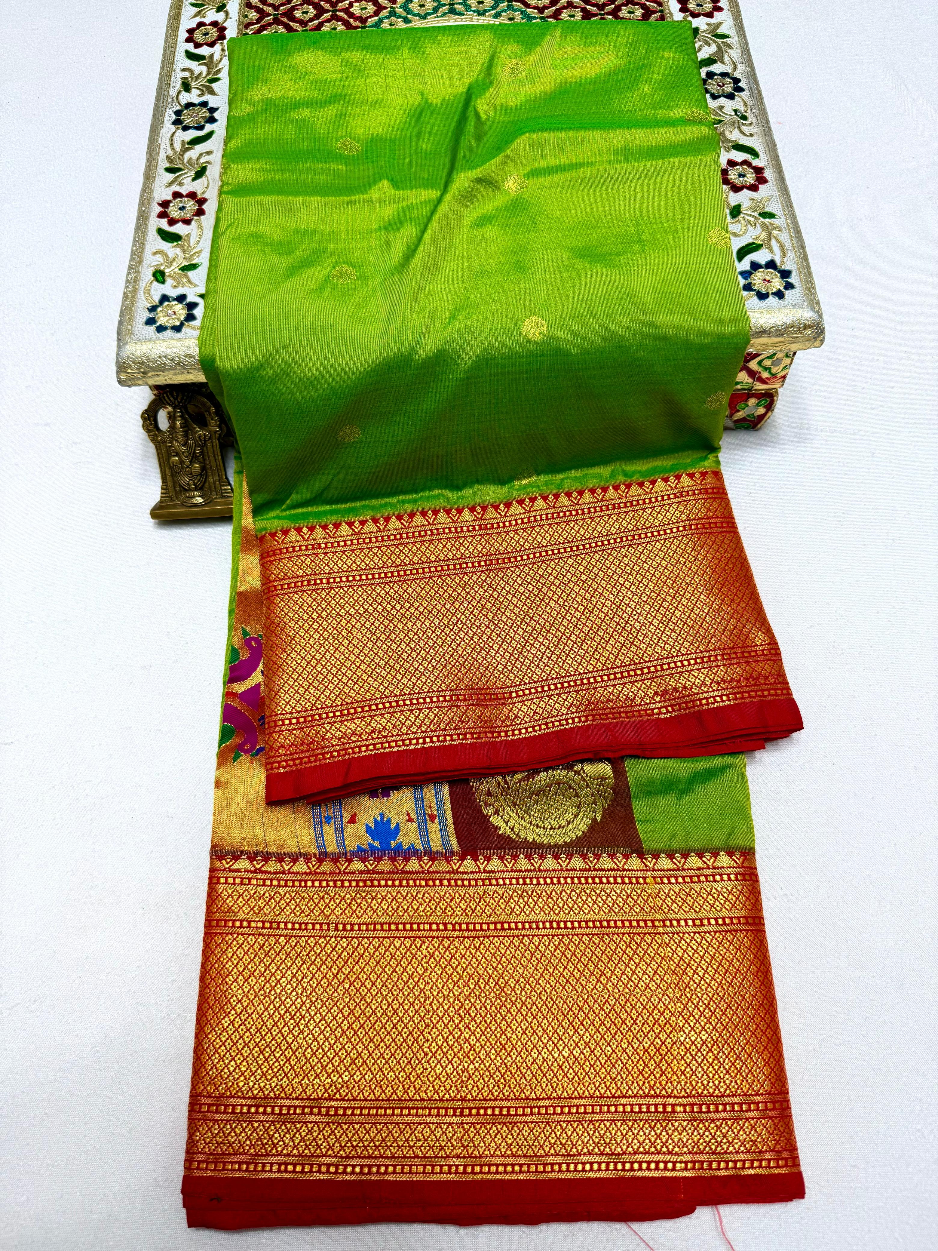 Traditional saree with green, red, and gold colors on a white background
