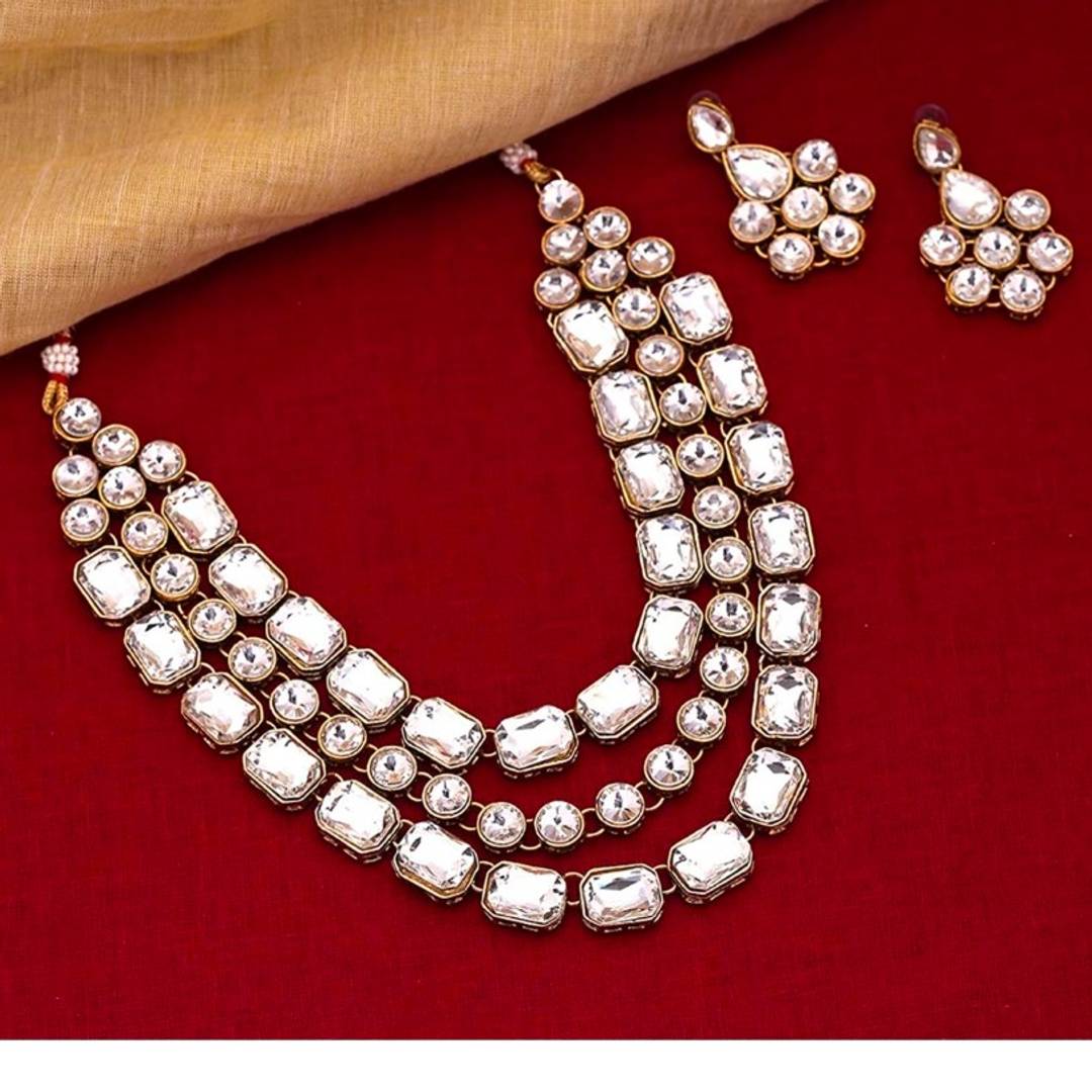 Multi-layered Wedding/ Party wear Necklace set in gold-tone representing Crystal embellished for Graceful looks. Goes well on Party /wedding Occasion.